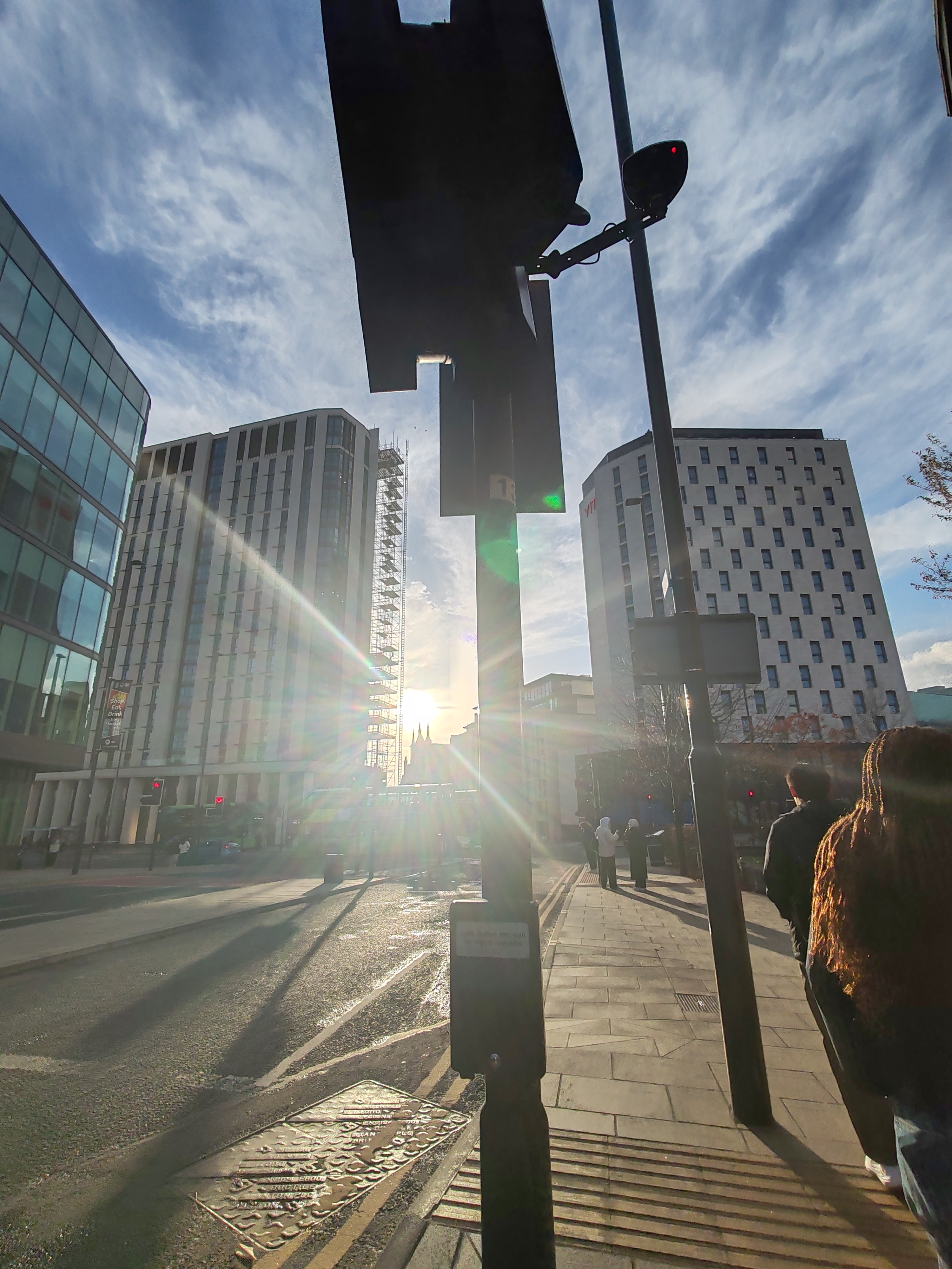 Modern glass towers with sun flare
